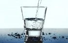Clean water being poured into a clear glass